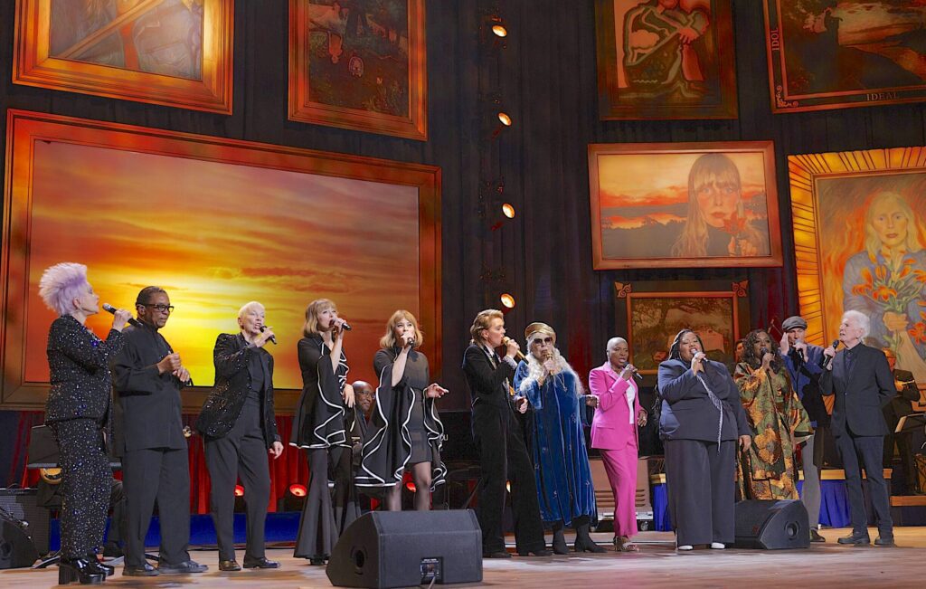 An all-star ensemble cast performs at Joni Mitchell’s Gershwin Prize concert on March 1. The artworks are enlargements of Mitchell’s paintings. Courtesy LOC. Photo by Shawn Miller.